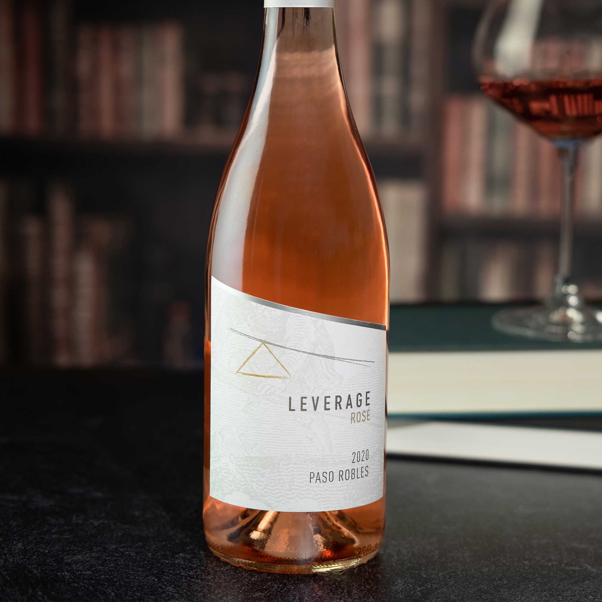 Leverage Rosé 2020 wine bottle with a glass of rosé wine in the background.